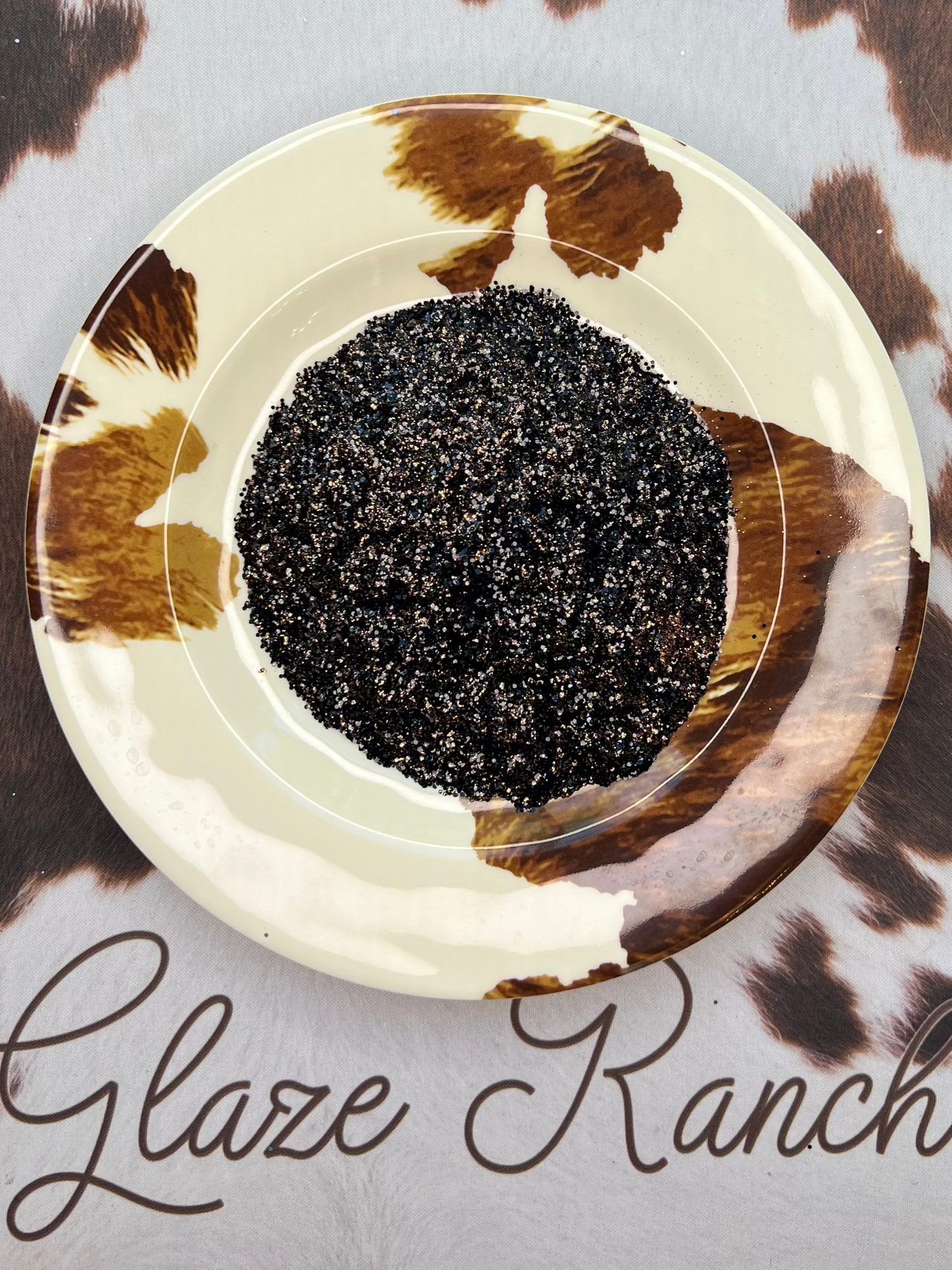 Small dish with black and copper glitter mixed.