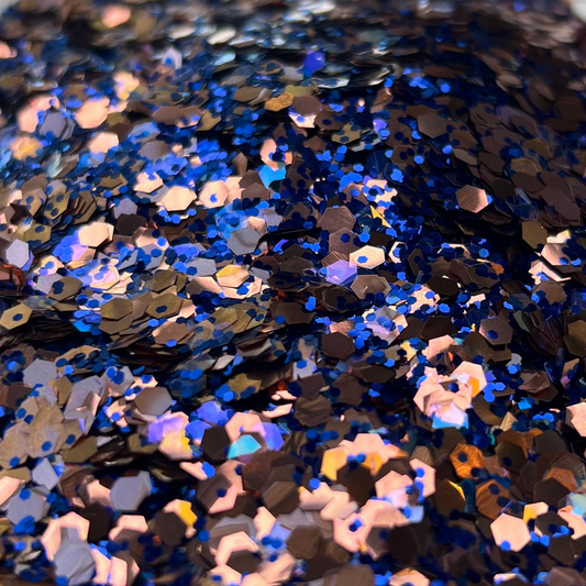 Close-up of blue and gold sequins on a patterned surface.