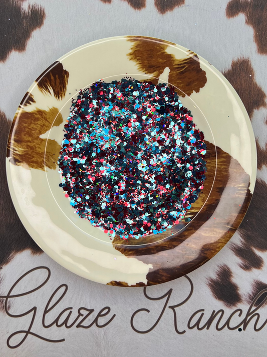 Decorative plate with multicolored glitter on a cow print background, branded 'Glaze Ranch'.