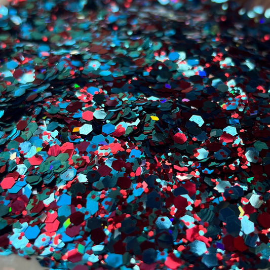 Colorful glitter on a white plate with a blurred background