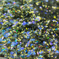 Decorative plate with glittery green substance on a patterned surface