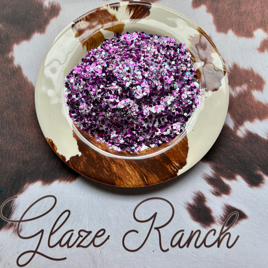 Decorative plate with glitter blend on a cow print background, featuring 'Glaze Ranch' branding.
