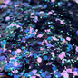 Multicolored glitter on a white plate with brown floral patterns