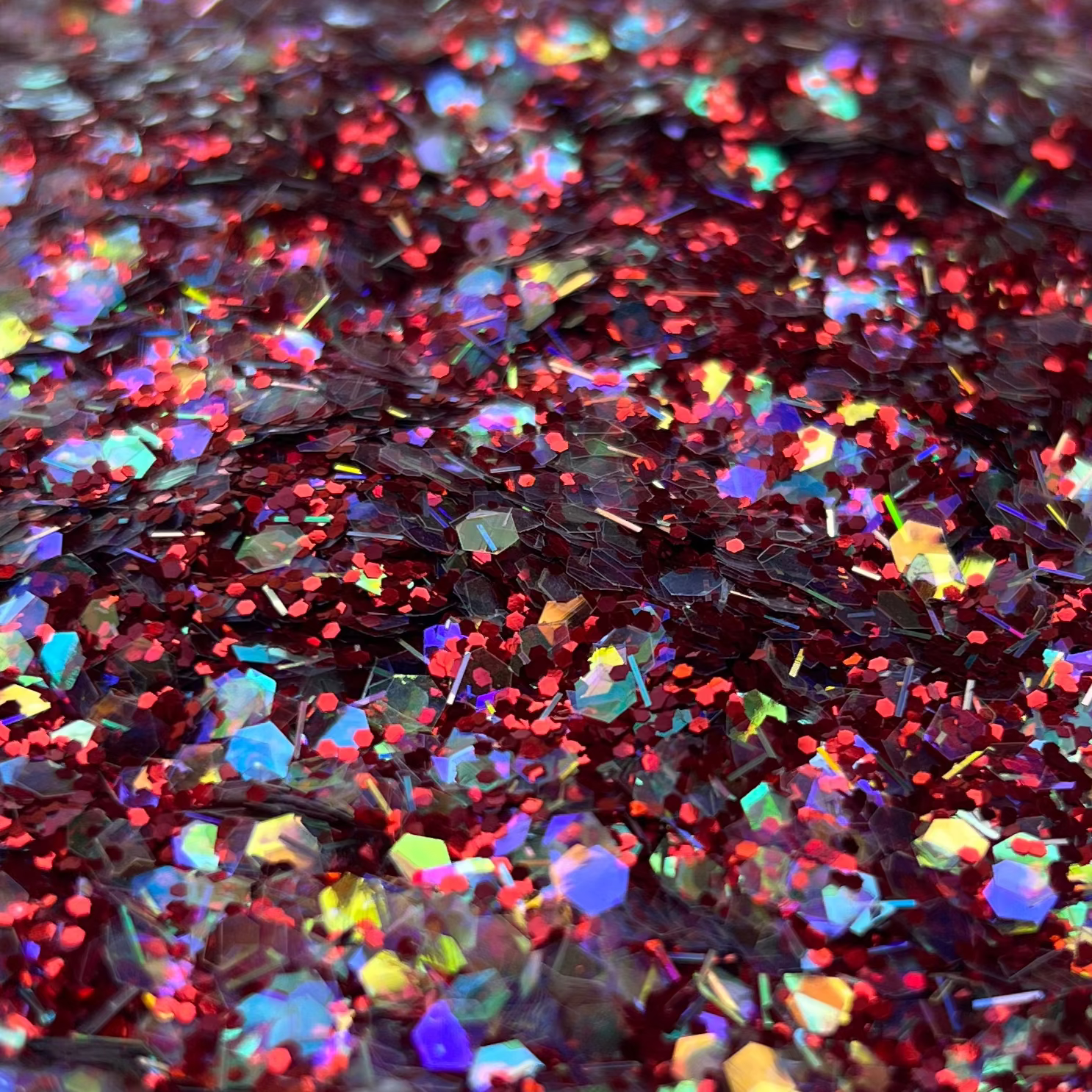 Colorful glitter in a white container on a brown surface