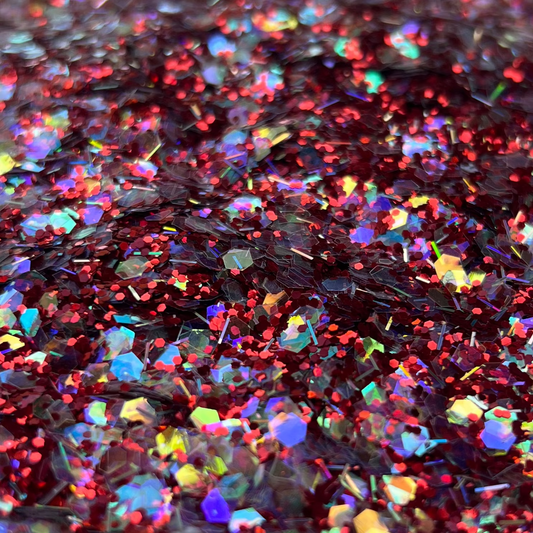 Colorful glitter in a white container on a brown surface
