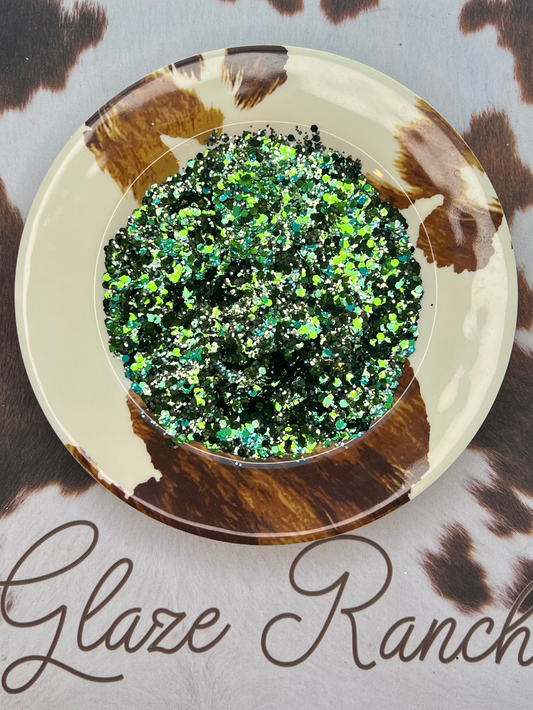 Green glittery substance in a dish on a cow print surface with 'Glaze Ranch' branding.