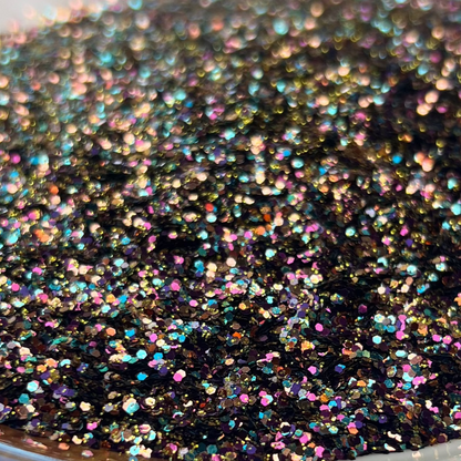 Decorative plate with black glittery substance on a brown and white surface