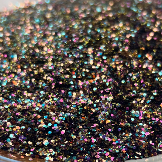 Decorative plate with black glittery substance on a brown and white surface