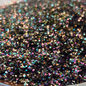 Decorative plate with black glittery substance on a brown and white surface