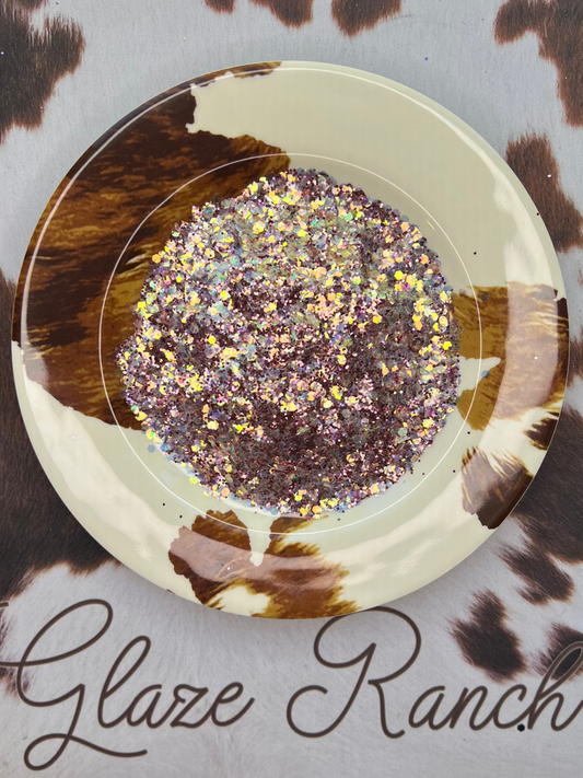 Decorative item with glitter and brush on a cow print background, featuring 'Glaze Ranch' branding.
