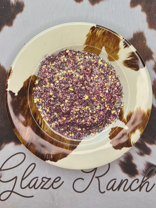 Decorative plate with a pink and iridescent glitter on a cowhide-patterned surface, featuring 'Glaze Ranch' branding.
