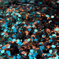 Turquoise, Brown, and copper mixed glitter in a cowhide print bowl.