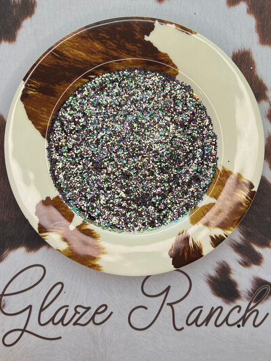 Decorative plate with glittery center on a cowhide surface, branded 'Glaze Ranch'.